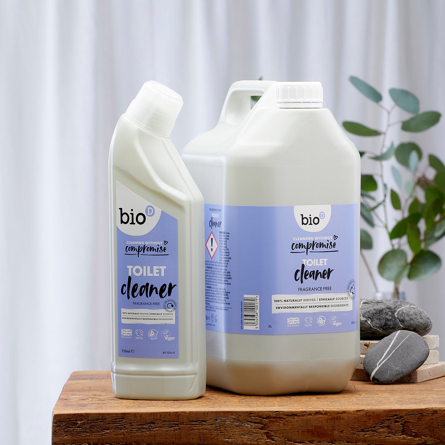  Bio-D 750ml natural toilet cleaner and 5 Litre tub on a wooden table and white background