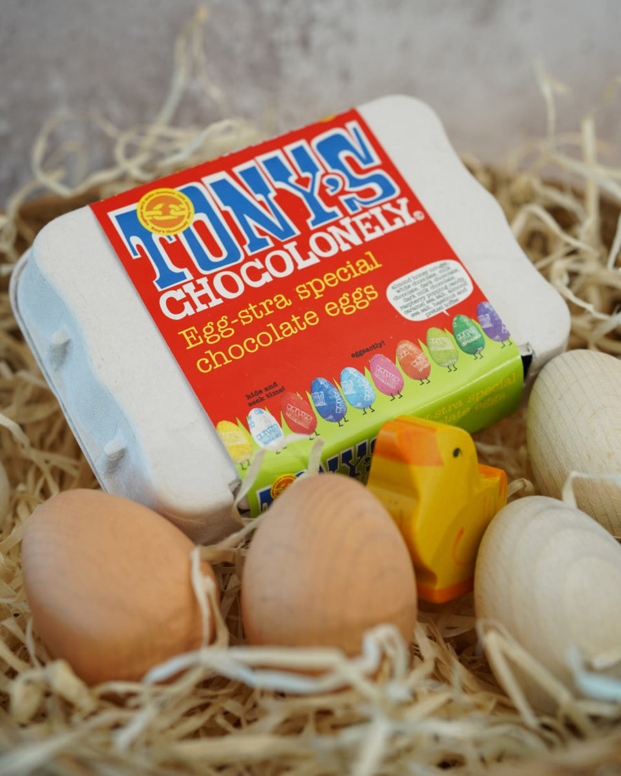 Tonys chocolonely egg-stra special fairtrade mini chocolate eggs in a basket full of straw