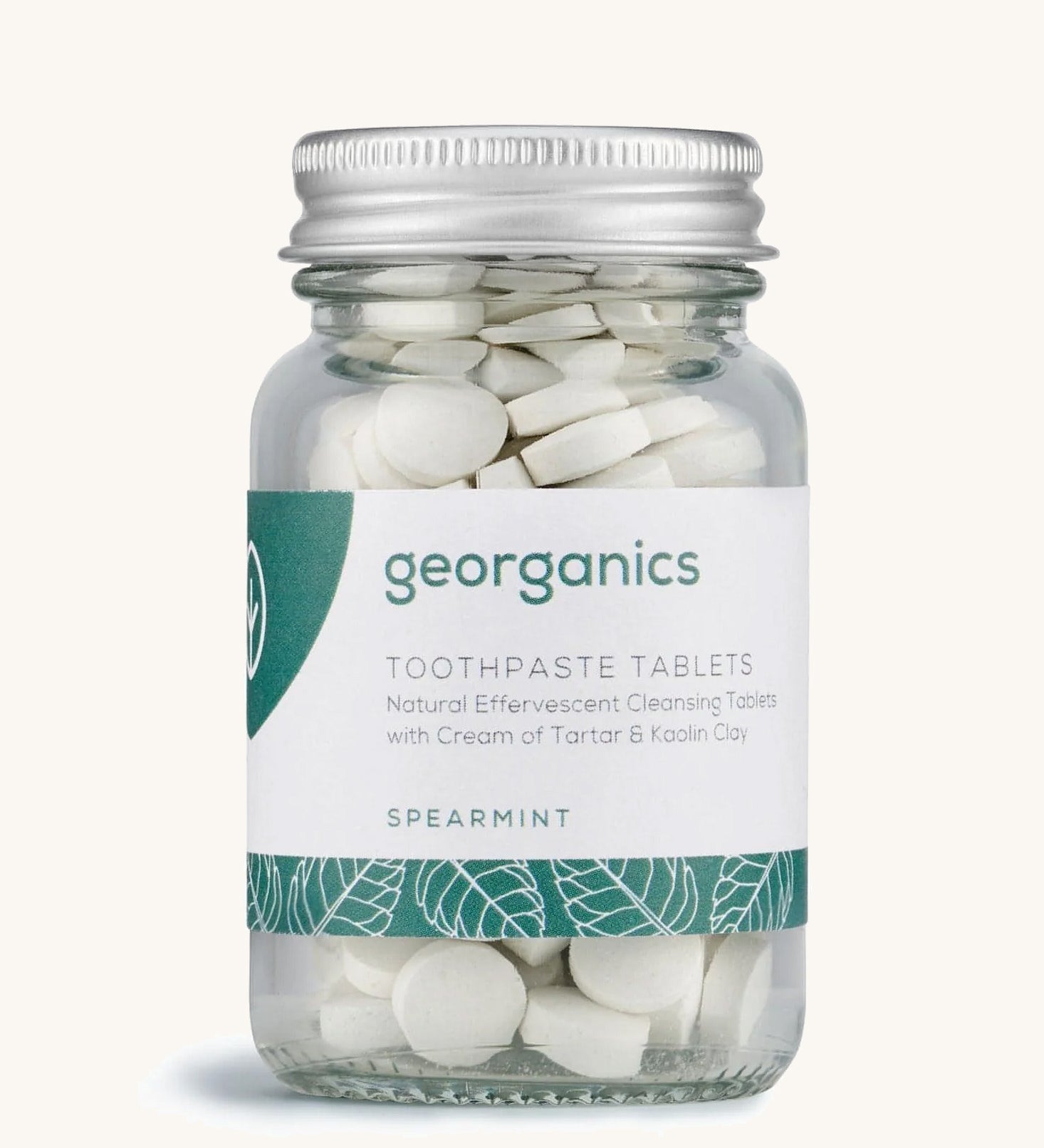 A jar of the Georganics spearmint toothpaste tablets on a cream background