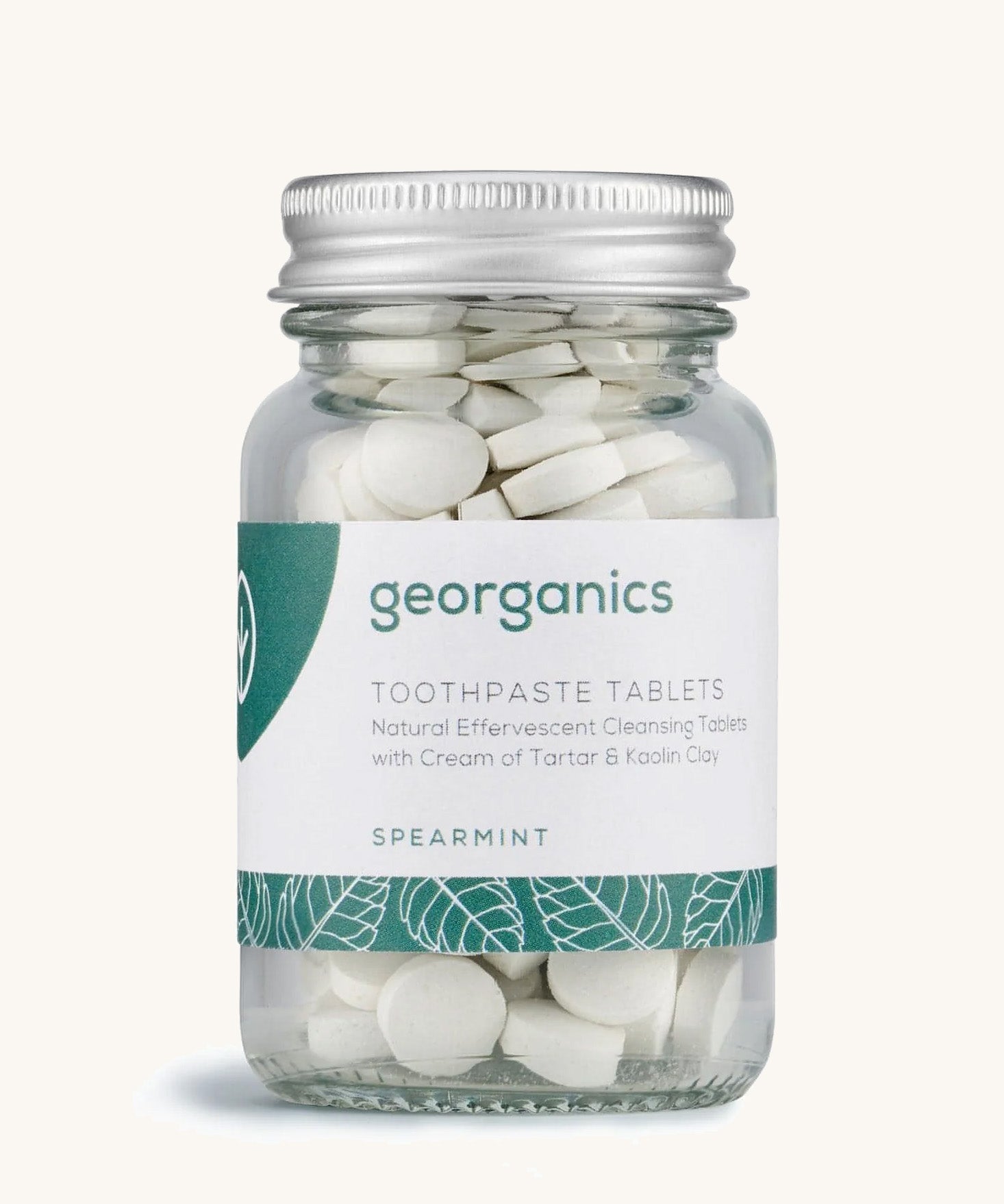 A jar of the Georganics spearmint toothpaste tablets on a cream background