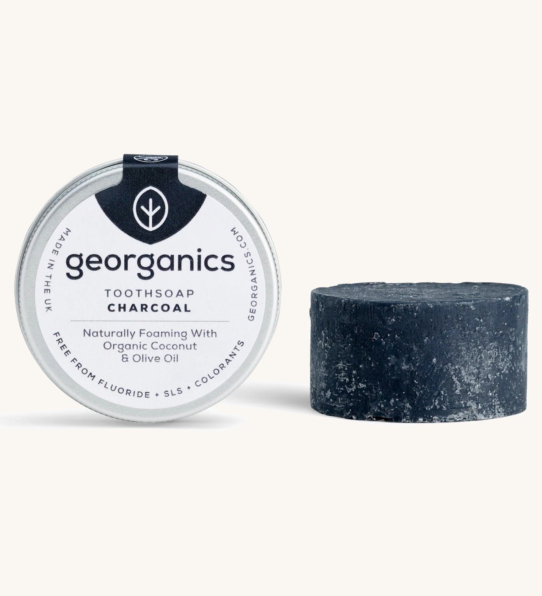 A tin of the Georganics charcoal toothsoap with the tooth soap next to it