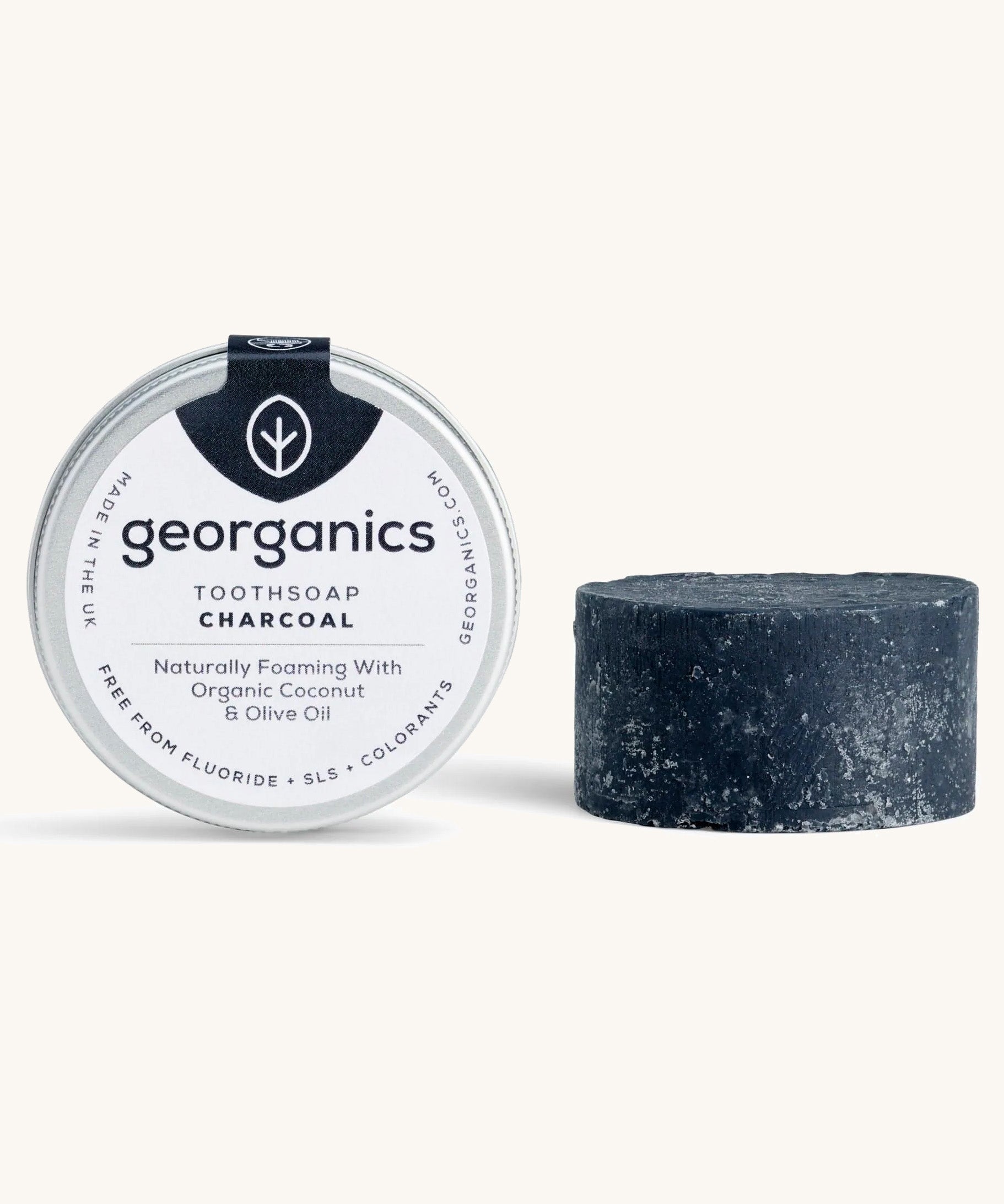 A tin of the Georganics charcoal toothsoap with the tooth soap next to it