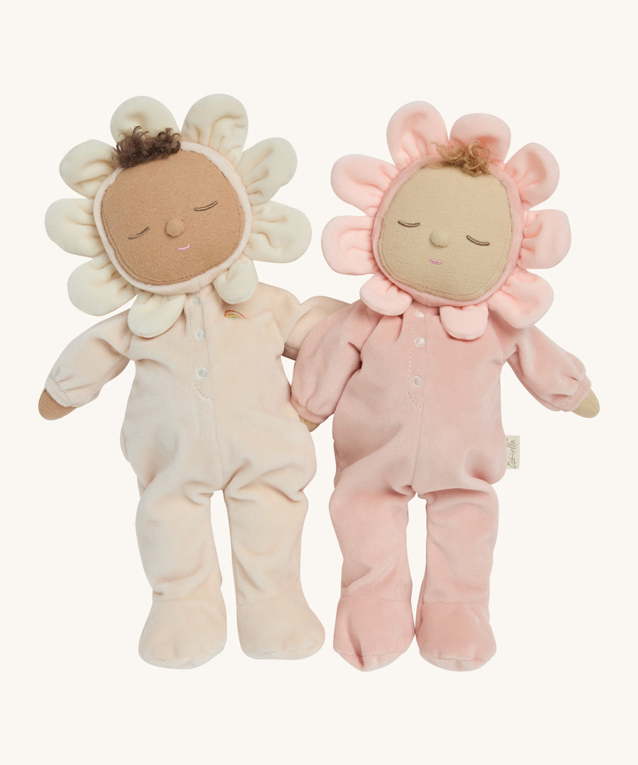 The light pink and cream dozy dinkum dolls standing next to eachother on a cream background.