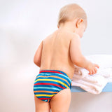 Close up of toddler stood wearing the Totsbots eco-friendly swim stripe reusable swim pants on a white background