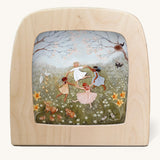 Spring dance Toverlux Magic Lamp Silhouette. Artwork By Robin-Pieterse. A delicate painting style illustration of 4 children dancing in a field surrounded by flowers and woodland animals