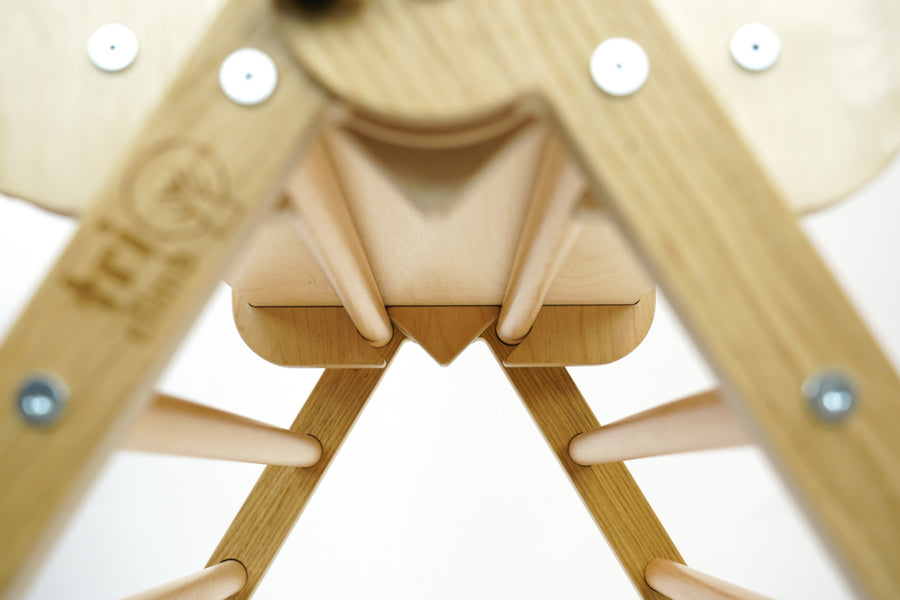 Close up of the Triclimb twr enclosure fixing on a natural triclimb kids climbing frame on a white background