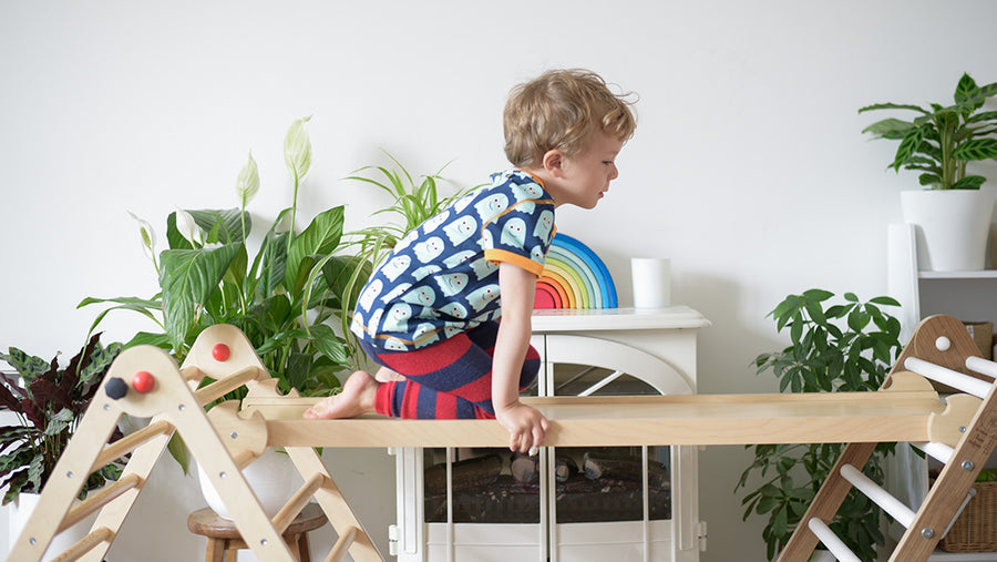 Child climbing on a Miri Board on top of two Triclimb piklers