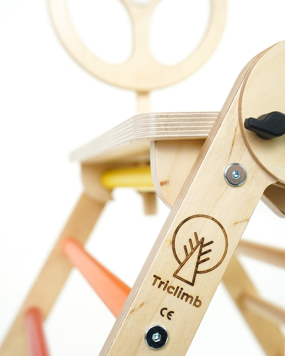 Close up of the Triclimb arben wooden steering wheel attachment on a white background