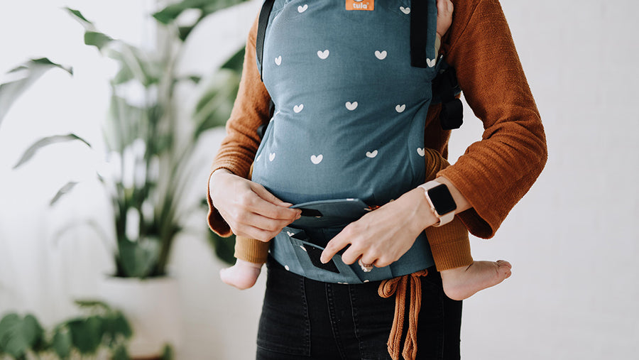 Person carrying a baby in the Tula baby carrier