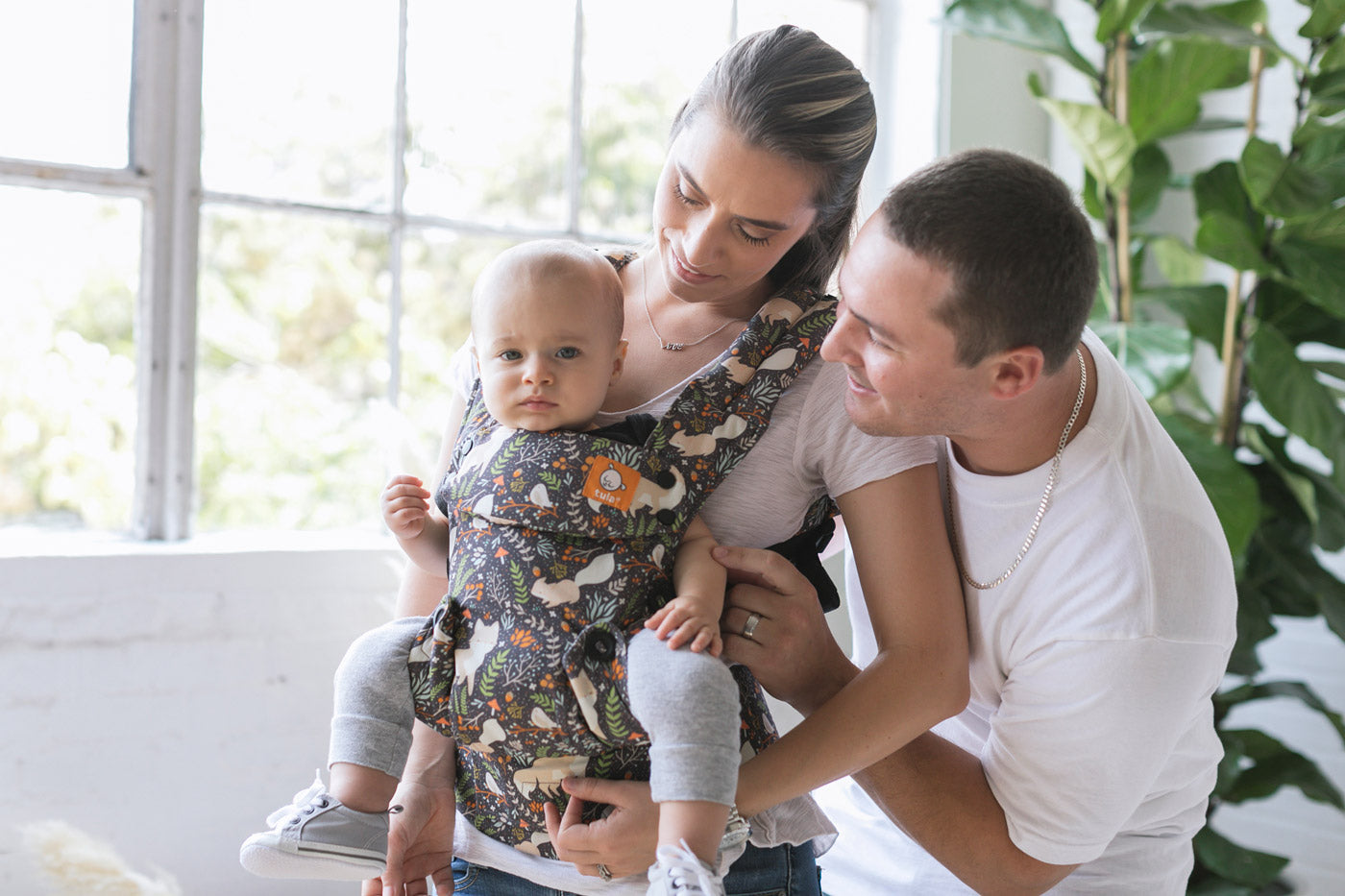 Close up of woman carrying a baby on her front in the Tula soft structured explore baby carrier