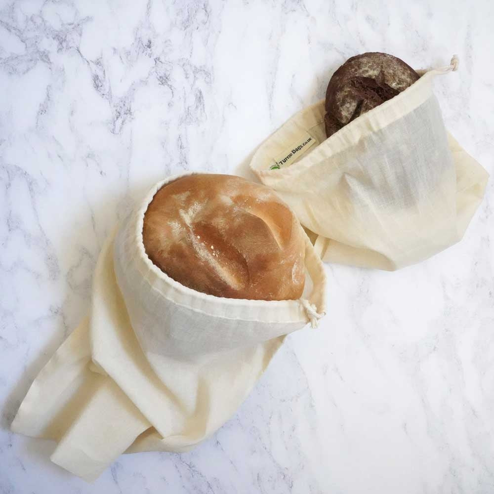 An image of the large and small organic cotton bread and produce bags from Turtle Bags with freshly baked loaves inside