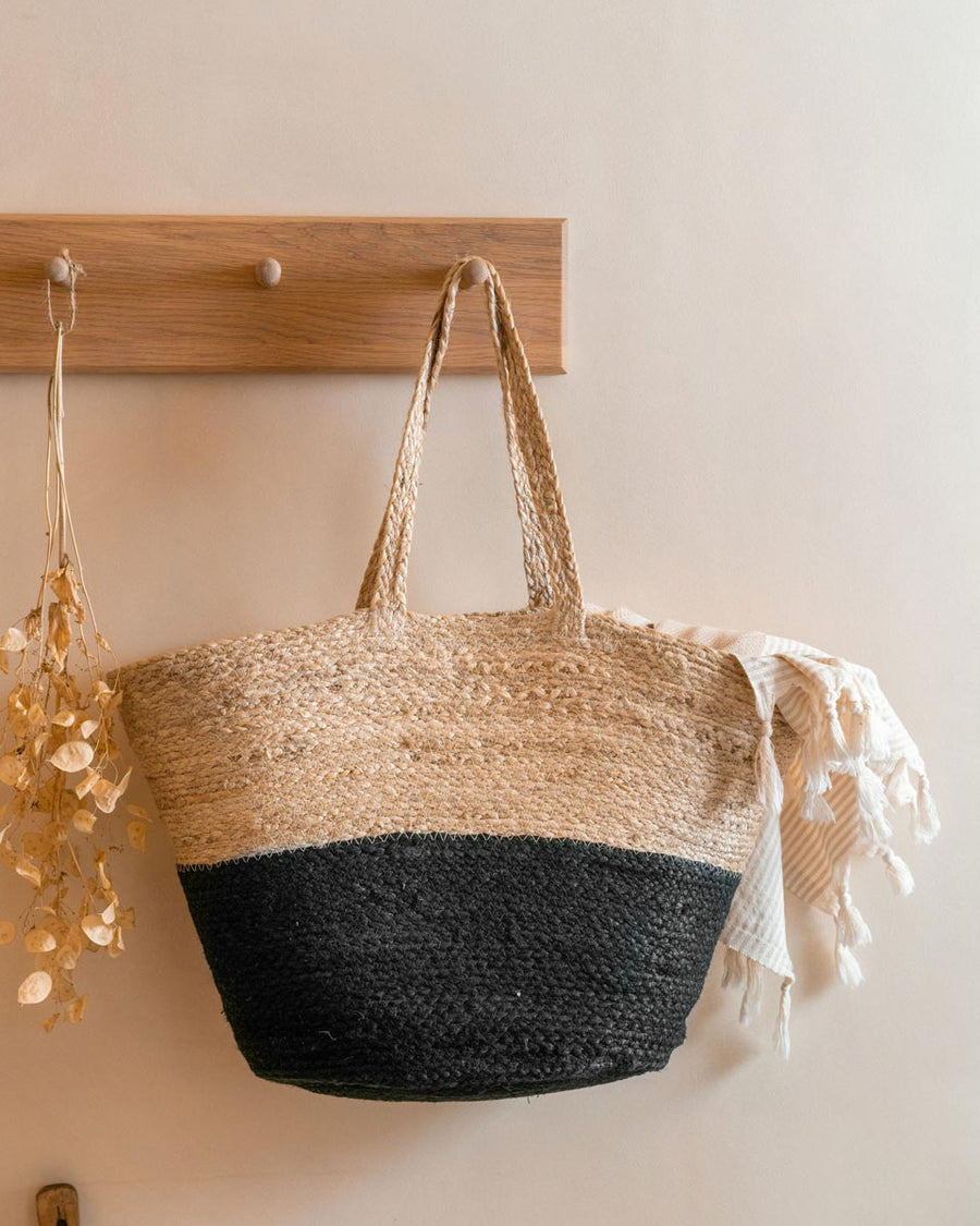 Turtle Bags black block colour jute basket hanging on a wooden coat hanger