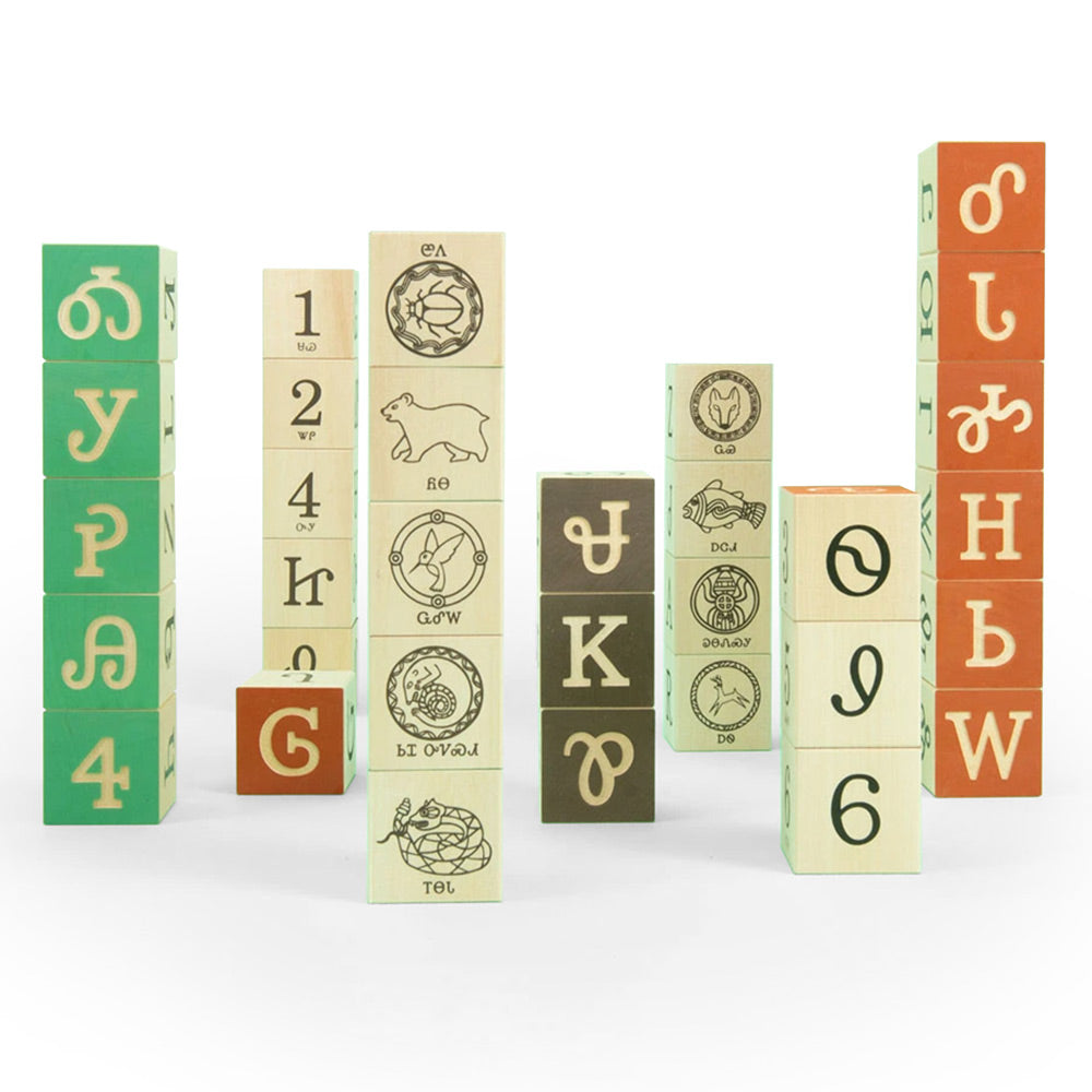 Uncle Goose Cherokee language wooden toy blocks stacked in towers on a white background