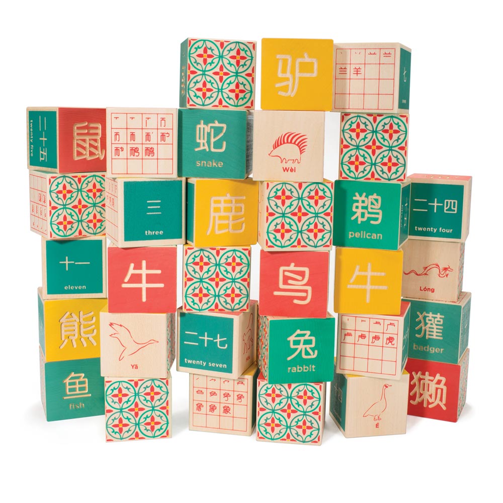 Uncle Goose eco-friendly Chinese language toy blocks stacked in a pile on a white background