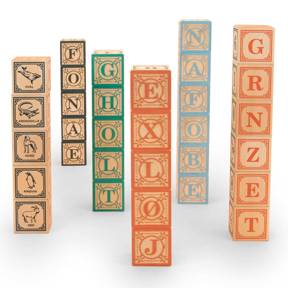 Uncle Goose eco-friendly wooden Danish language toy blocks in towers on a white background