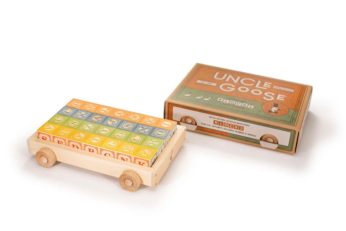 Uncle goose plastic free wooden toy wagon next to its box on a white background