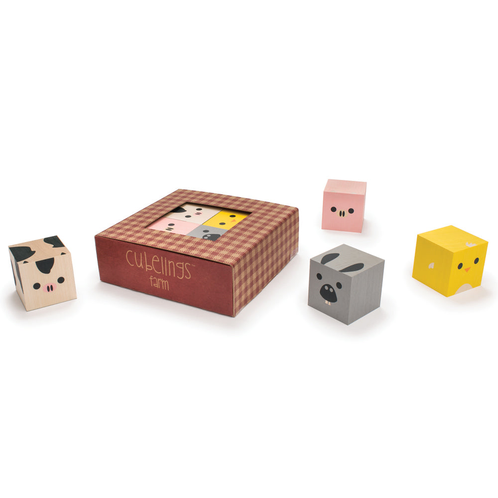 Uncle goose eco-friendly wooden farm cubelings blocks scattered on a white background next to their cardboard box