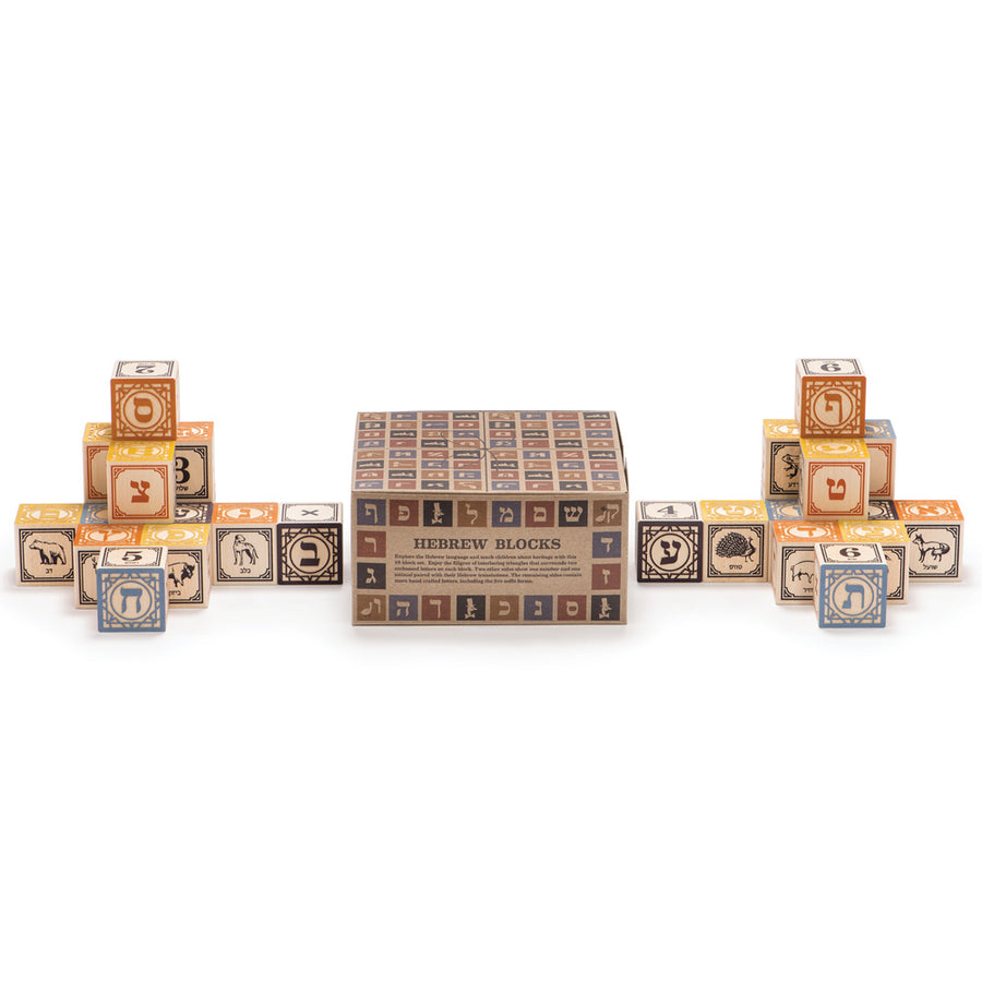 Uncle Goose plastic free wooden Hebrew toy blocks stacked in two piles on a white background next to their cardboard box