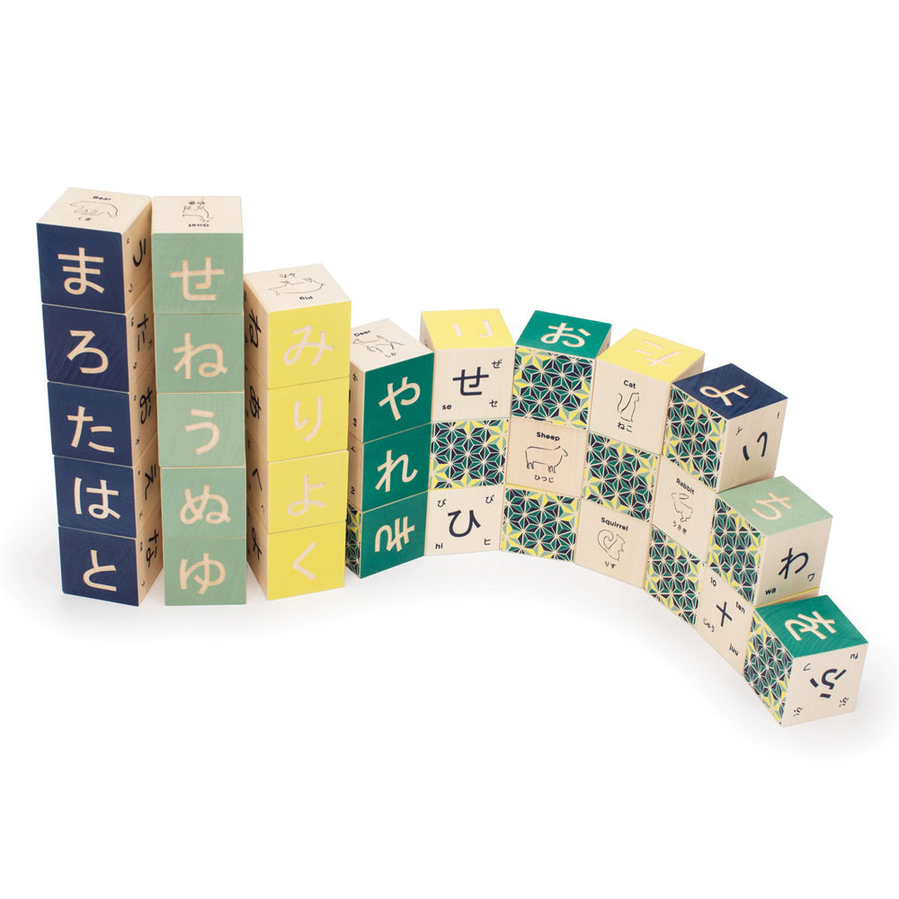 Uncle Goose wooden japanese language blocks stacked in a curvy pile on a white background