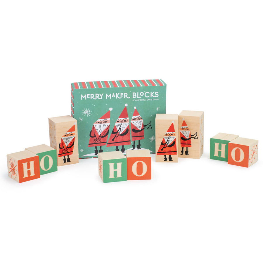 Uncle goose eco-friendly wooden merry maker toy blocks scattered on a white background next to their cardboard box