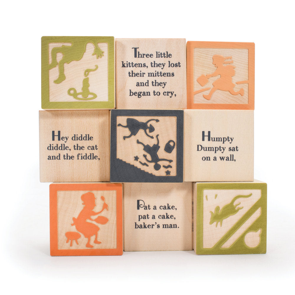 Uncle goose mini nursery rhyme toy blocks set stacked in a pile on a white background