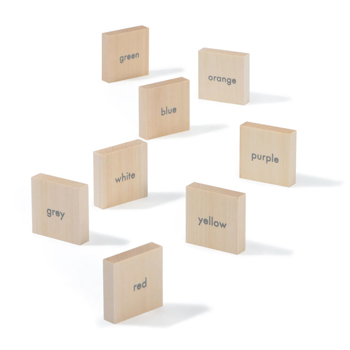 Uncle Goose kids wooden English language learning blocks scattered on a white background