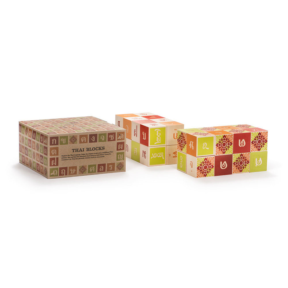 Uncle Goose wooden Thai blocks stacked in a pile next to their box on a white background