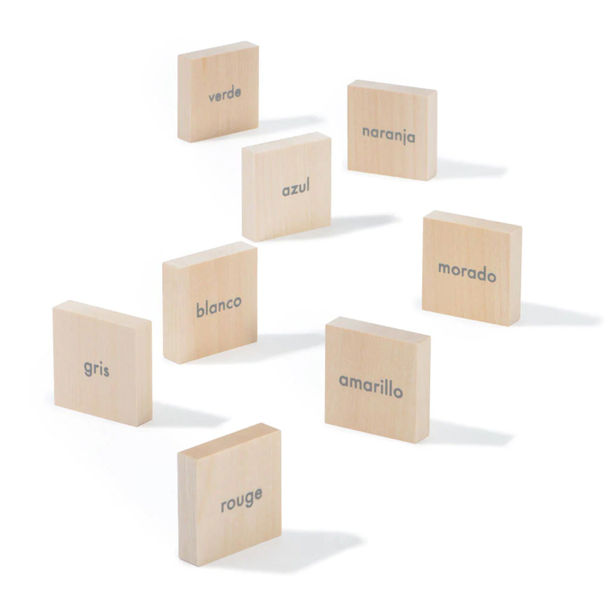 Uncle Goose kids wooden Spanish language learning blocks scattered on a white background