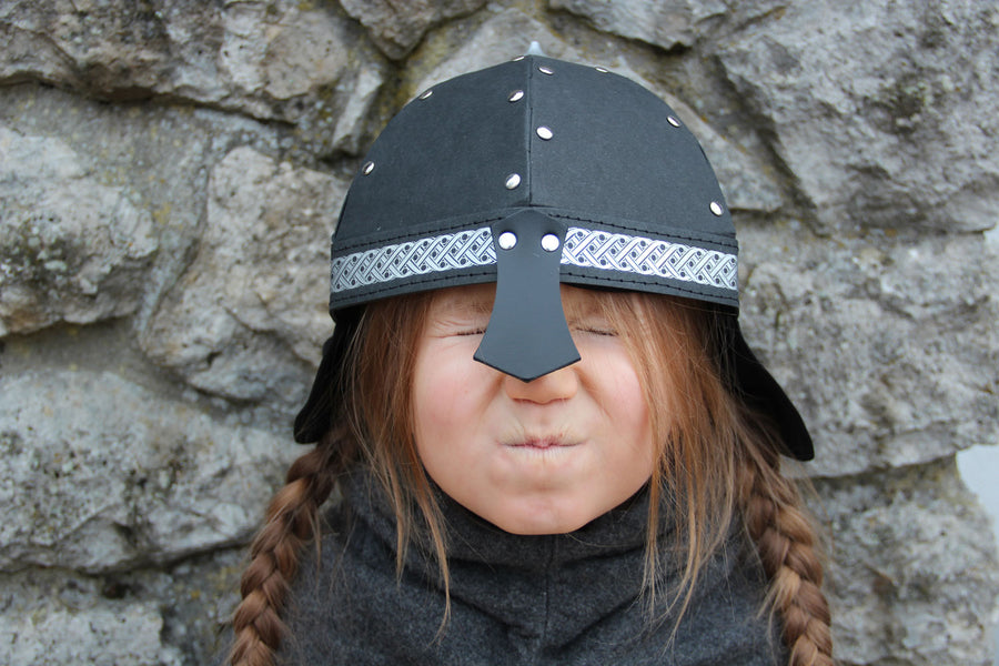 Child wearing the Vah Black Alamann Knight Helmet