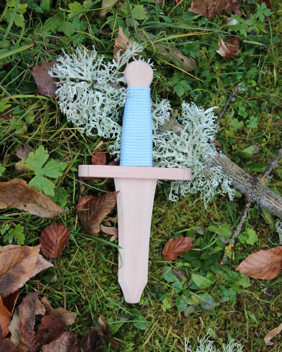 The dagger from the Vah Tristan Castle Mini Wooden Shield & Dagger Set pictured on grass