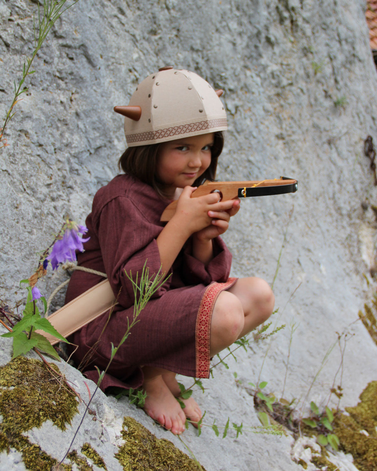 Child playing with the Vah Junior Wooden Bow toy