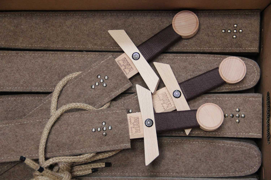 Three Vah Excalibur Wooden Sword Sets pictured on a pile of woolen felted  sheaths in a box