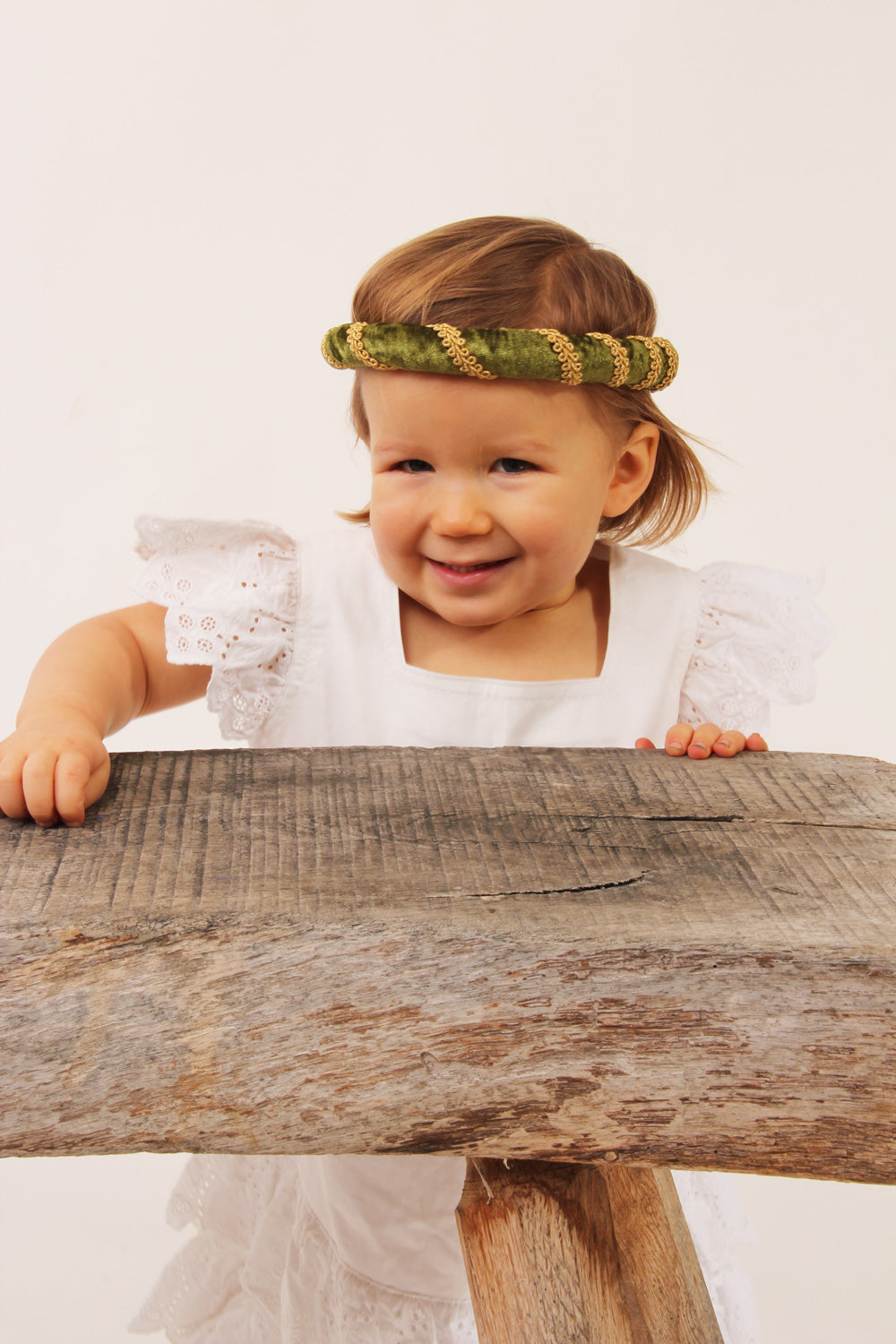 Child wearing the vah green Isabella Medieval Veil and a white dress