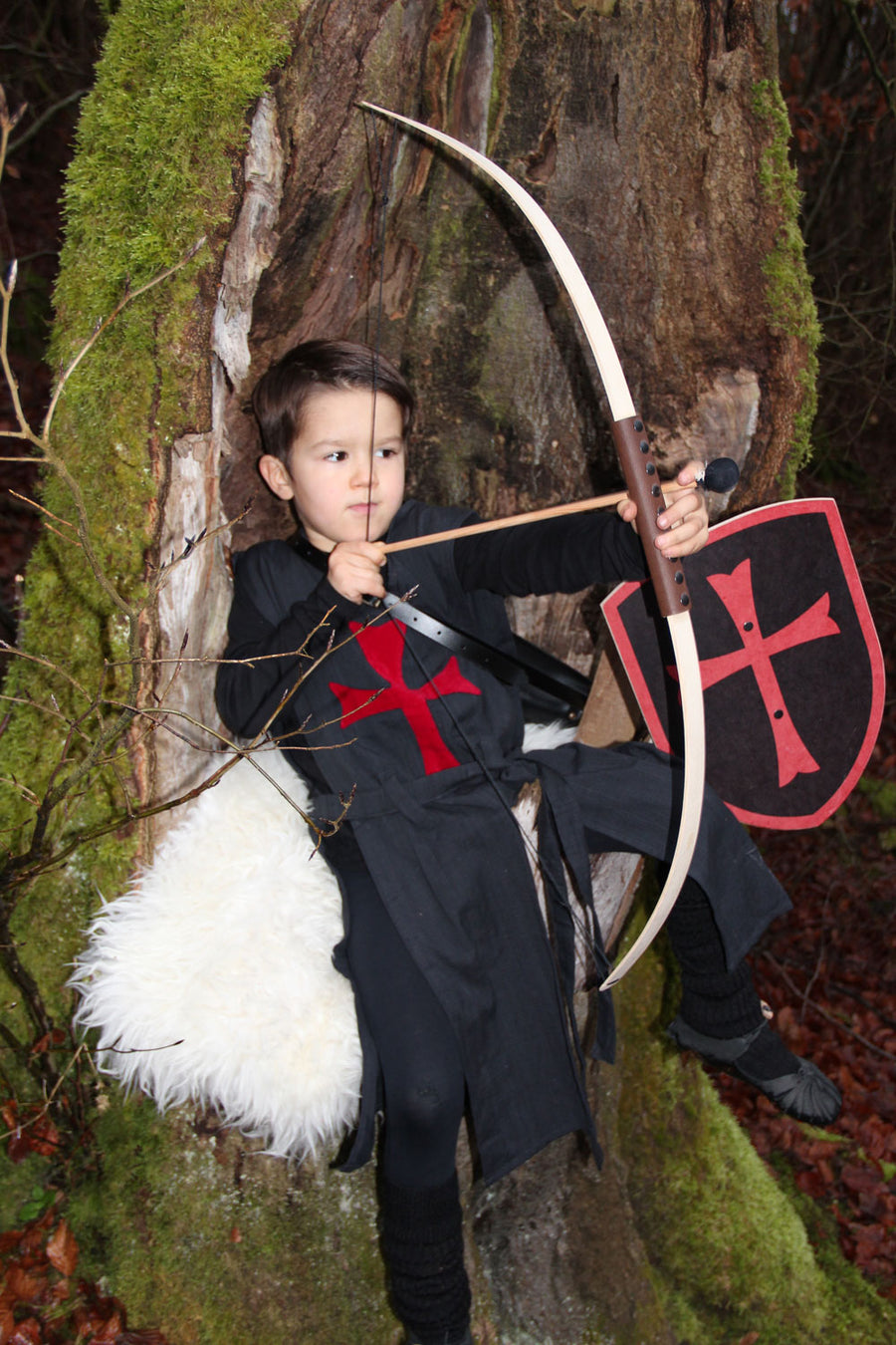 Child in fancy dress costume using the Vah Junior Wooden Bow