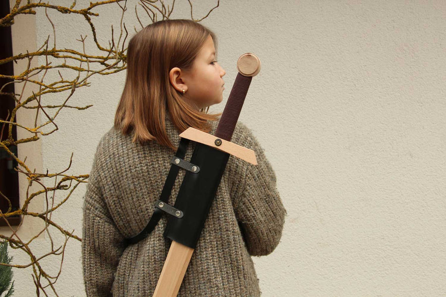 child wearing a sword on their back using the vah konrad back sword holder