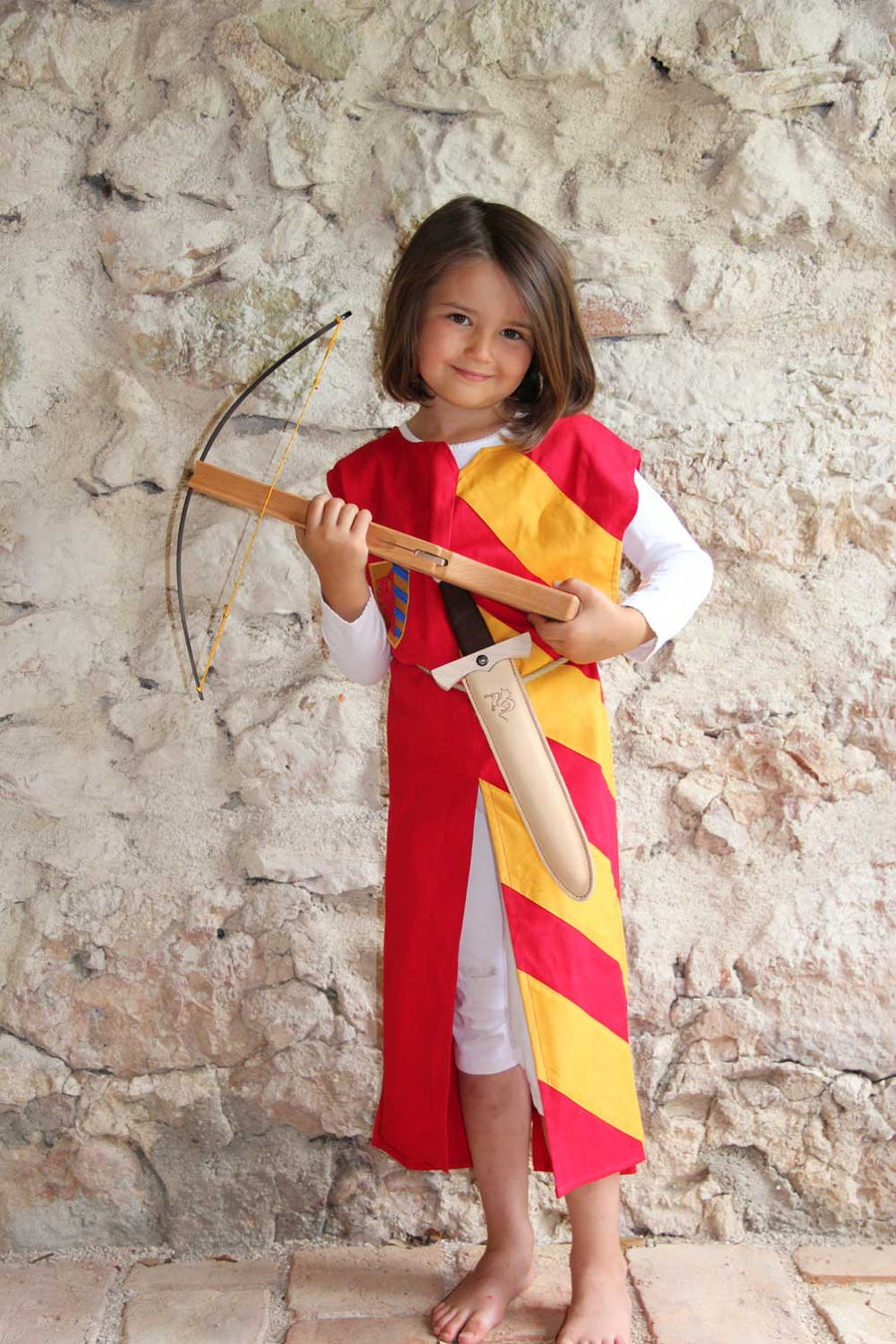 Child wearing a Vah red & yellow Lancelot costume Tunic