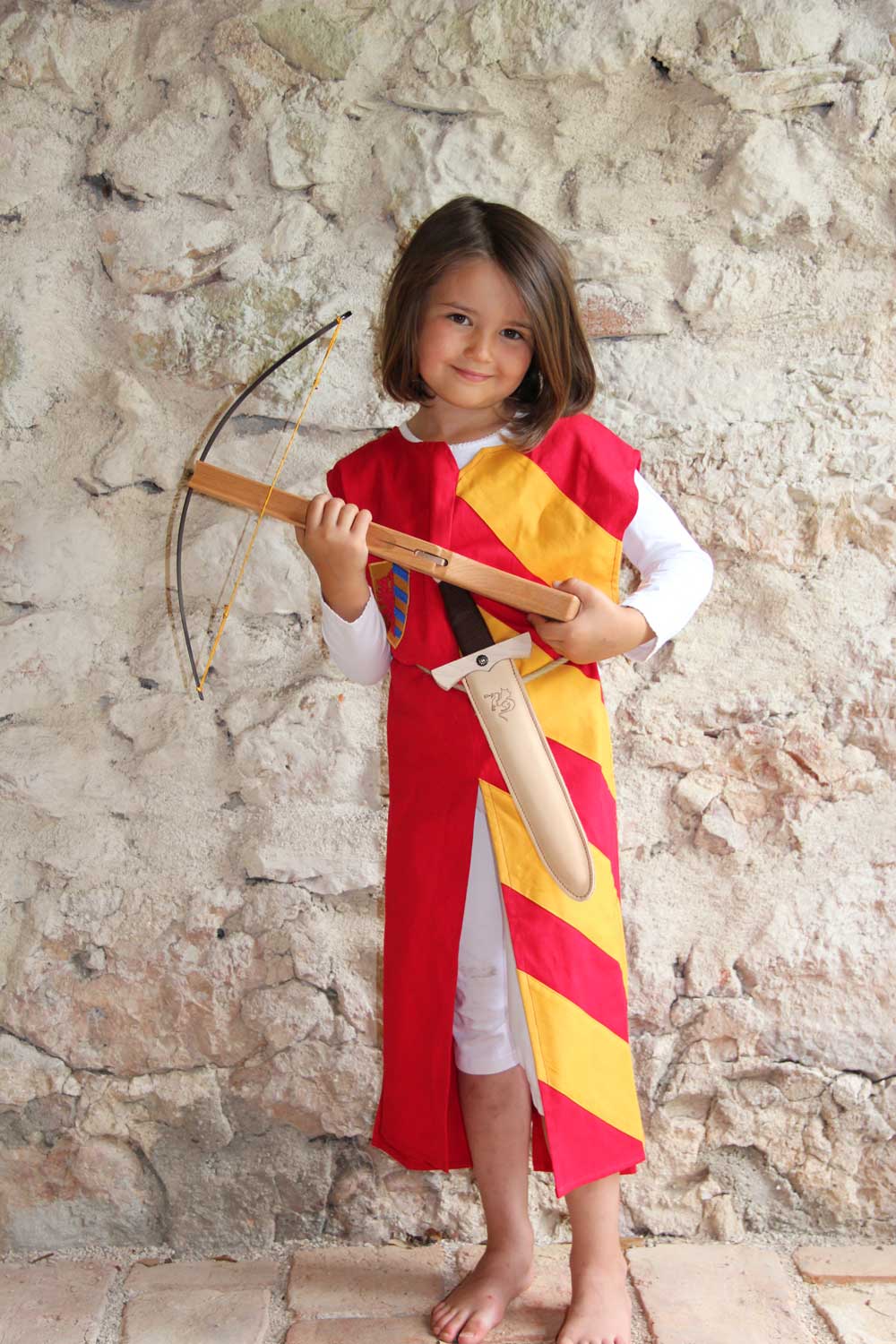 Child wearing a Vah red & yellow Lancelot costume Tunic