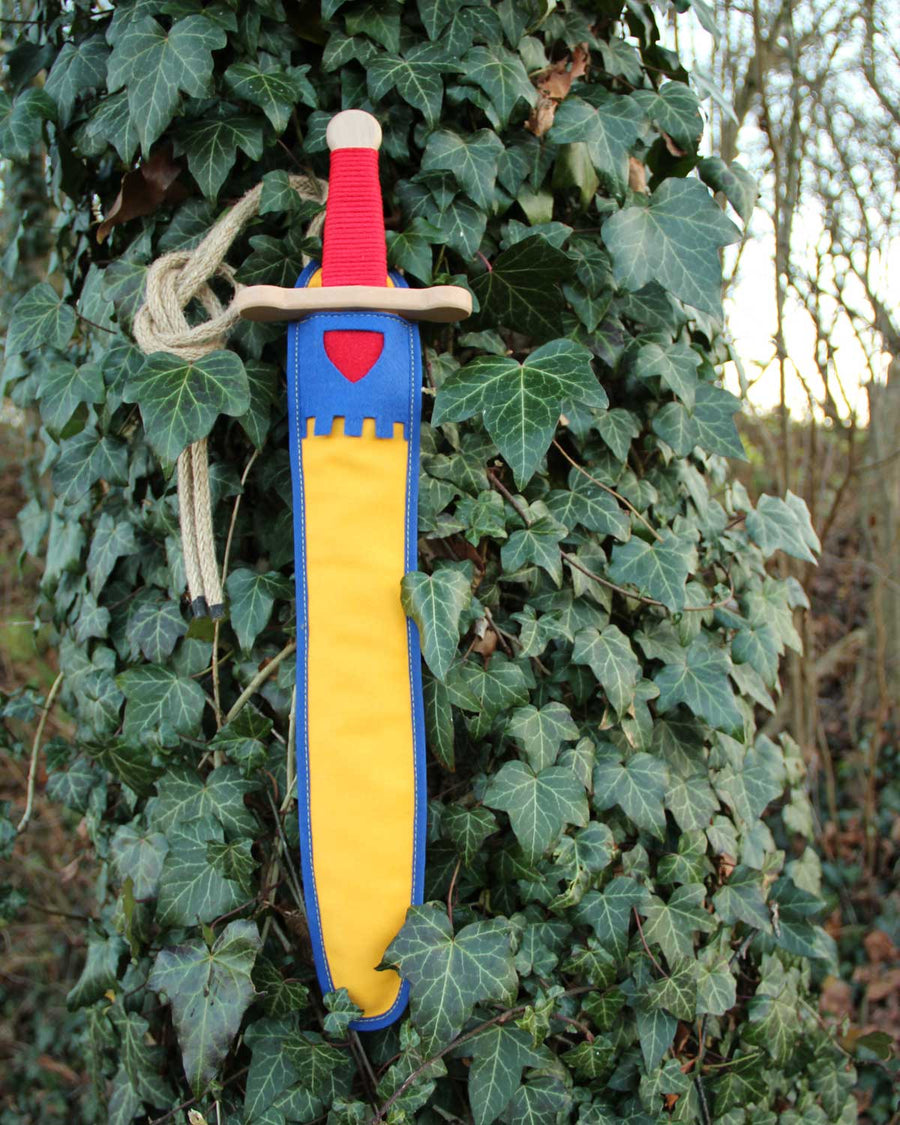 Vah Landsknecht Yellow & Blue Wooden Sword Set pictured on an ivy covered tree