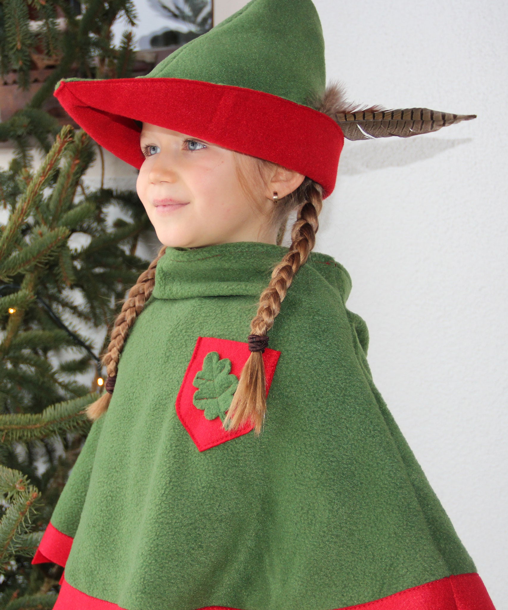 Child dressed up as robin hood wearing the vah robin hood cape and matching hat.