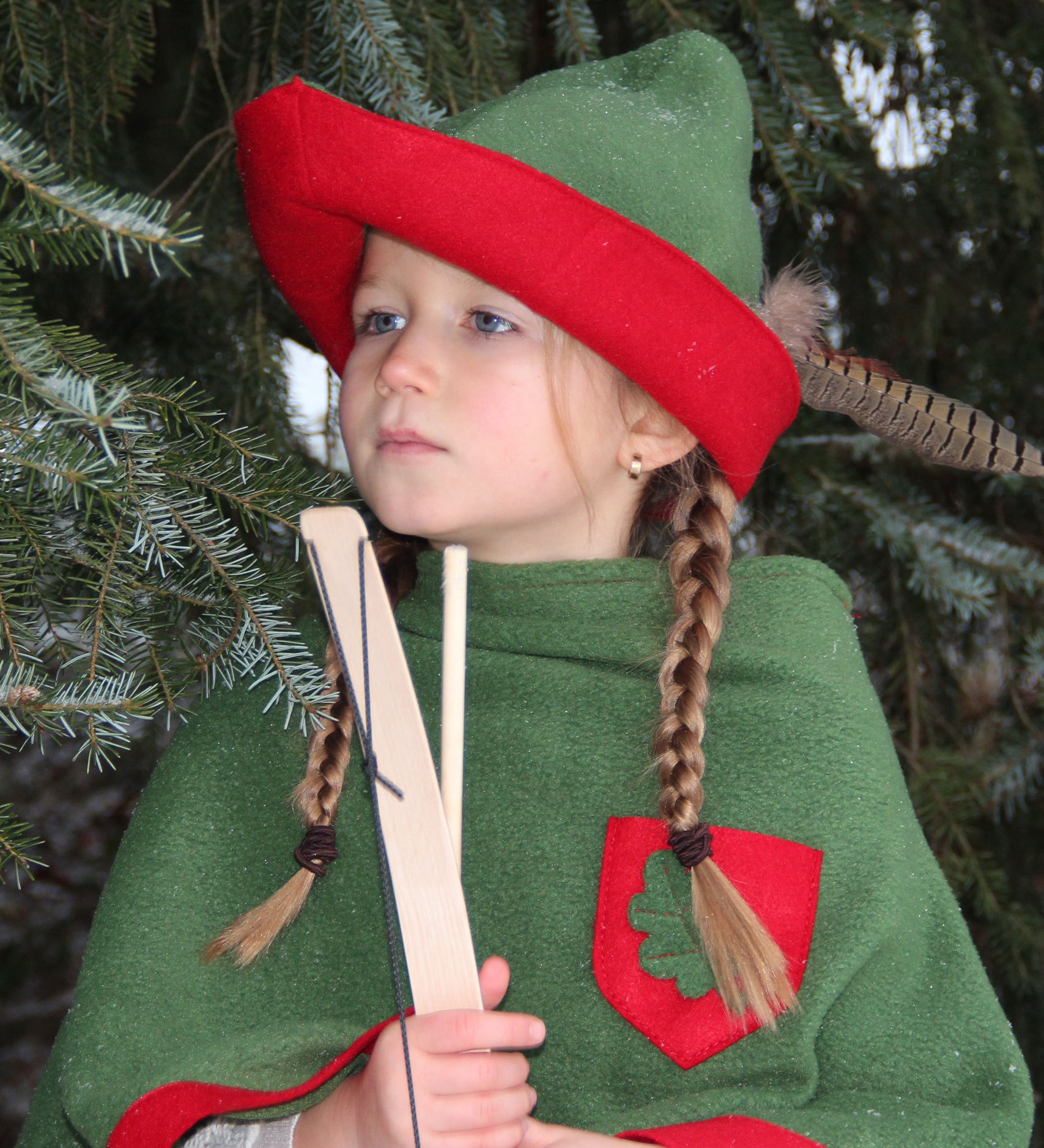 Child dressed up as robin hood wearing the vah robin hood cape and matching hat.