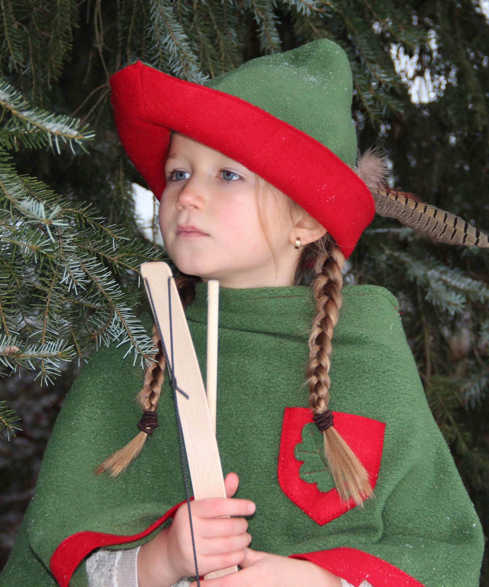 Child dressed up as robin hood wearing the vah robin hood cape and matching hat.