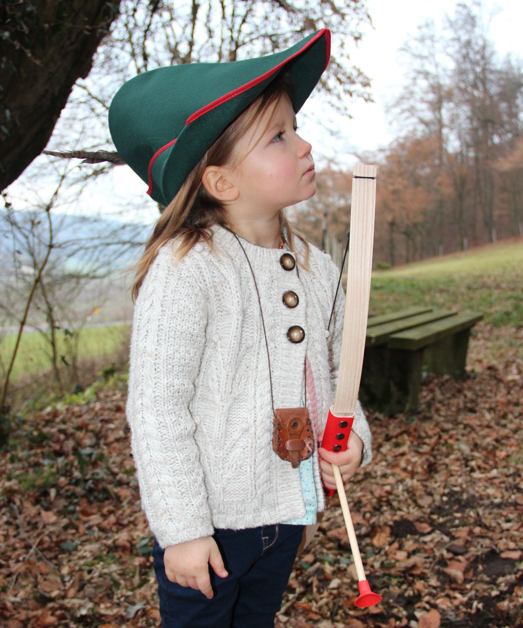 A child wearing a VAH robin hood hat playing with a bow and arrow.