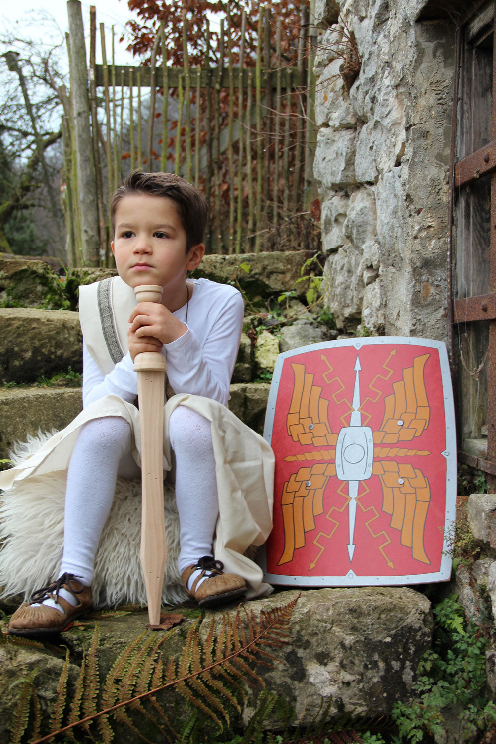 Child sitting on a step outdoors