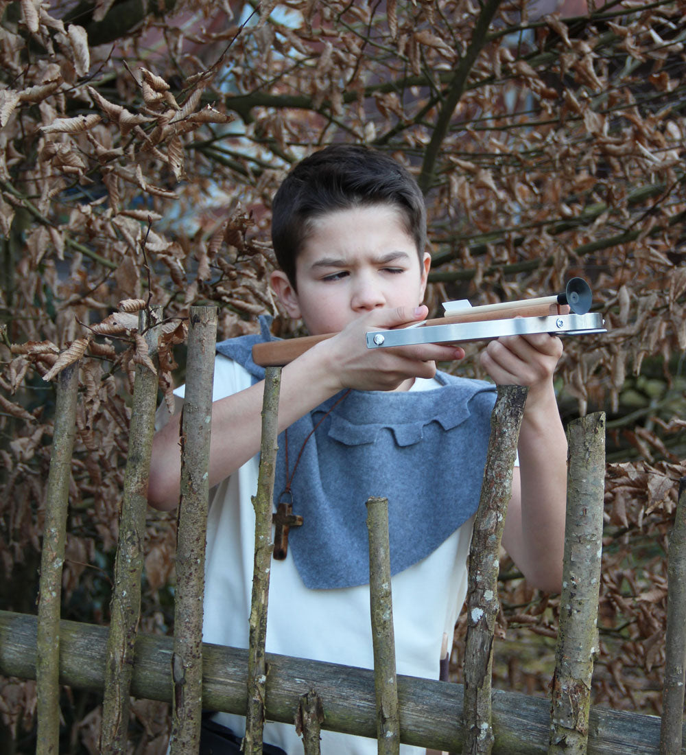 Child in fancy dress taking aim with the Vah Wooden Hunting Crossbow with Safety Arrows