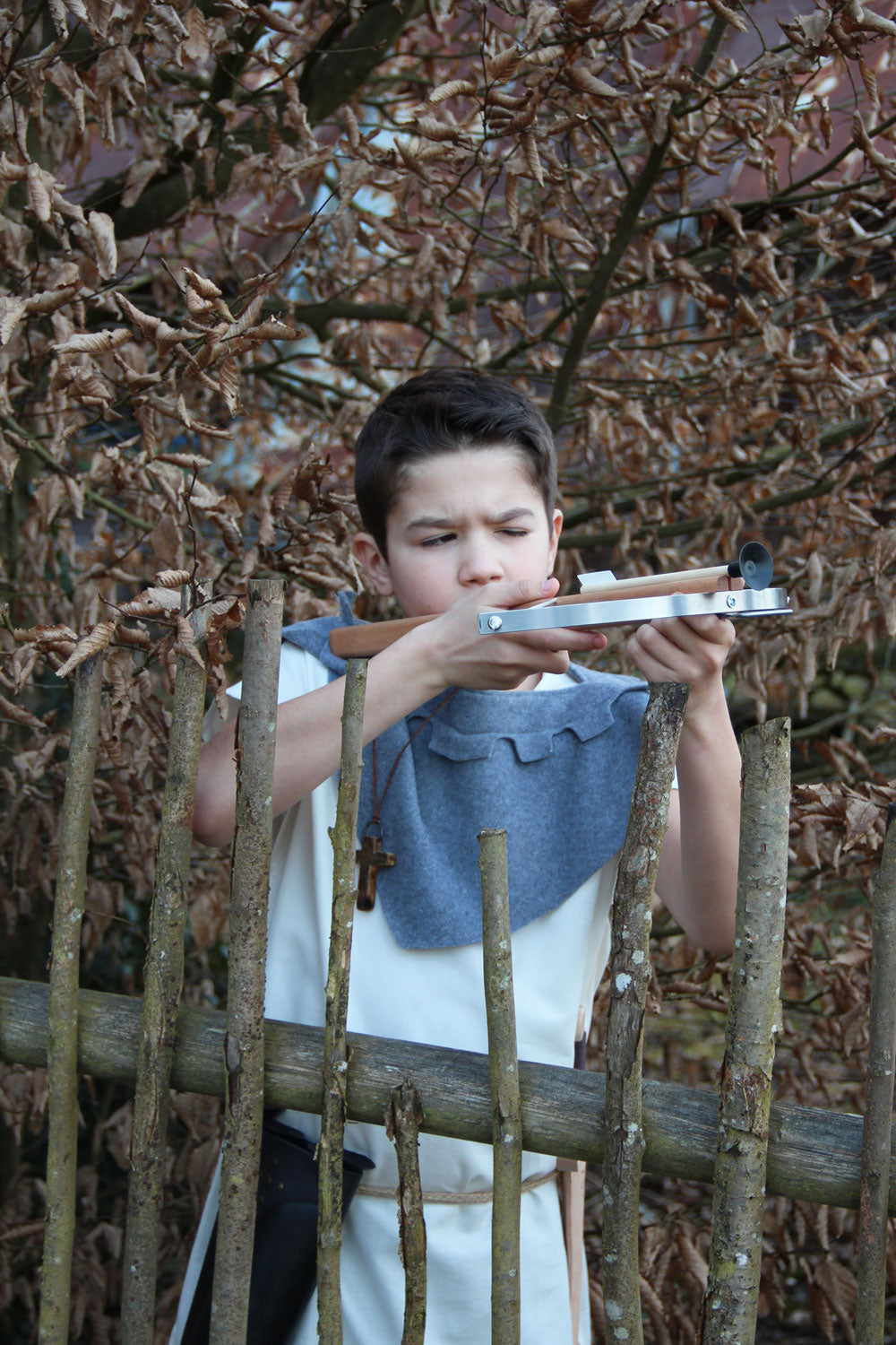 Child in fancy dress taking aim with the Vah Wooden Hunting Crossbow with Safety Arrows