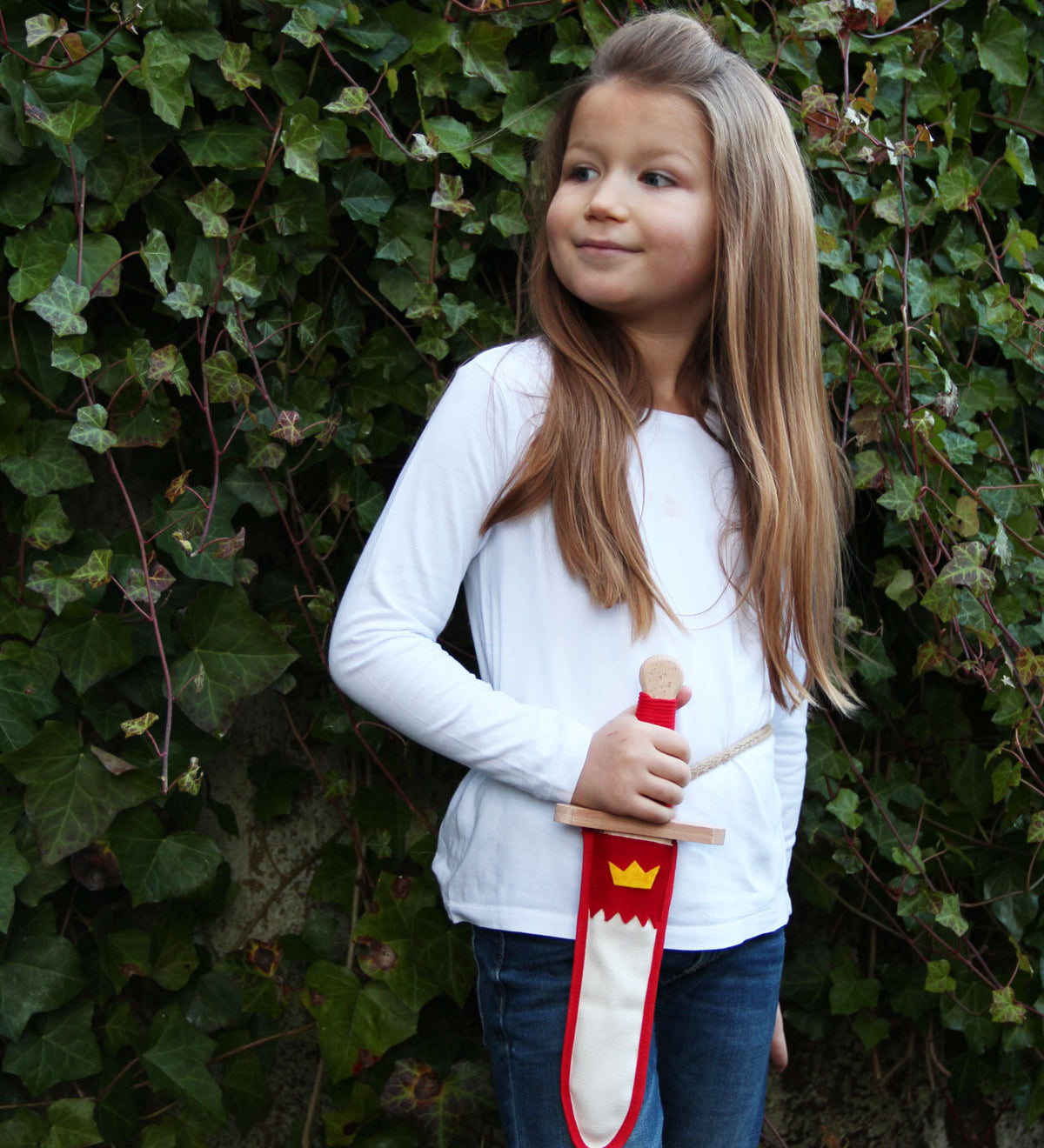 Child holding the Vah red and white coloured Lansquenet Wooden Sword Set