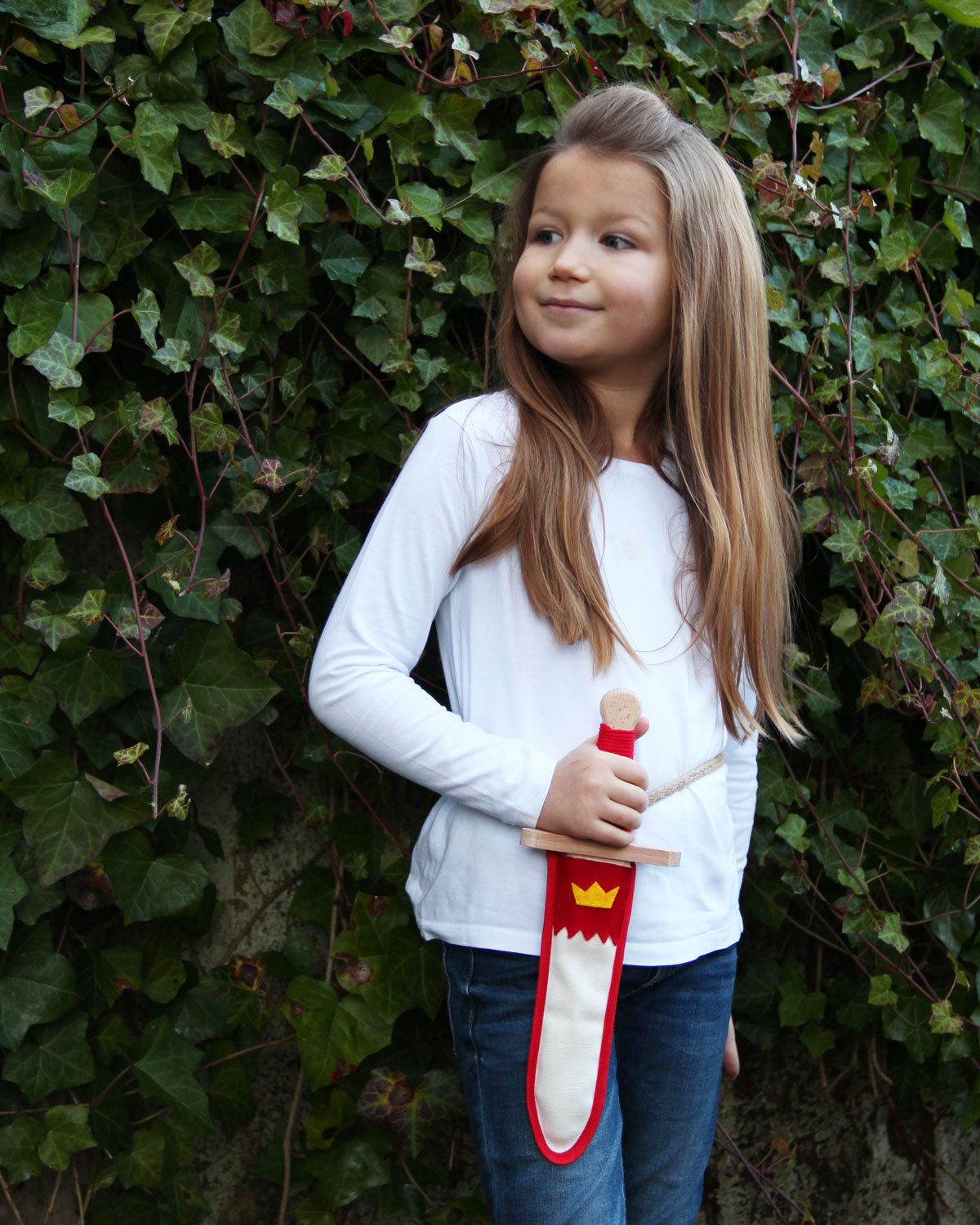 Child holding the Vah red and white coloured Lansquenet Wooden Sword Set