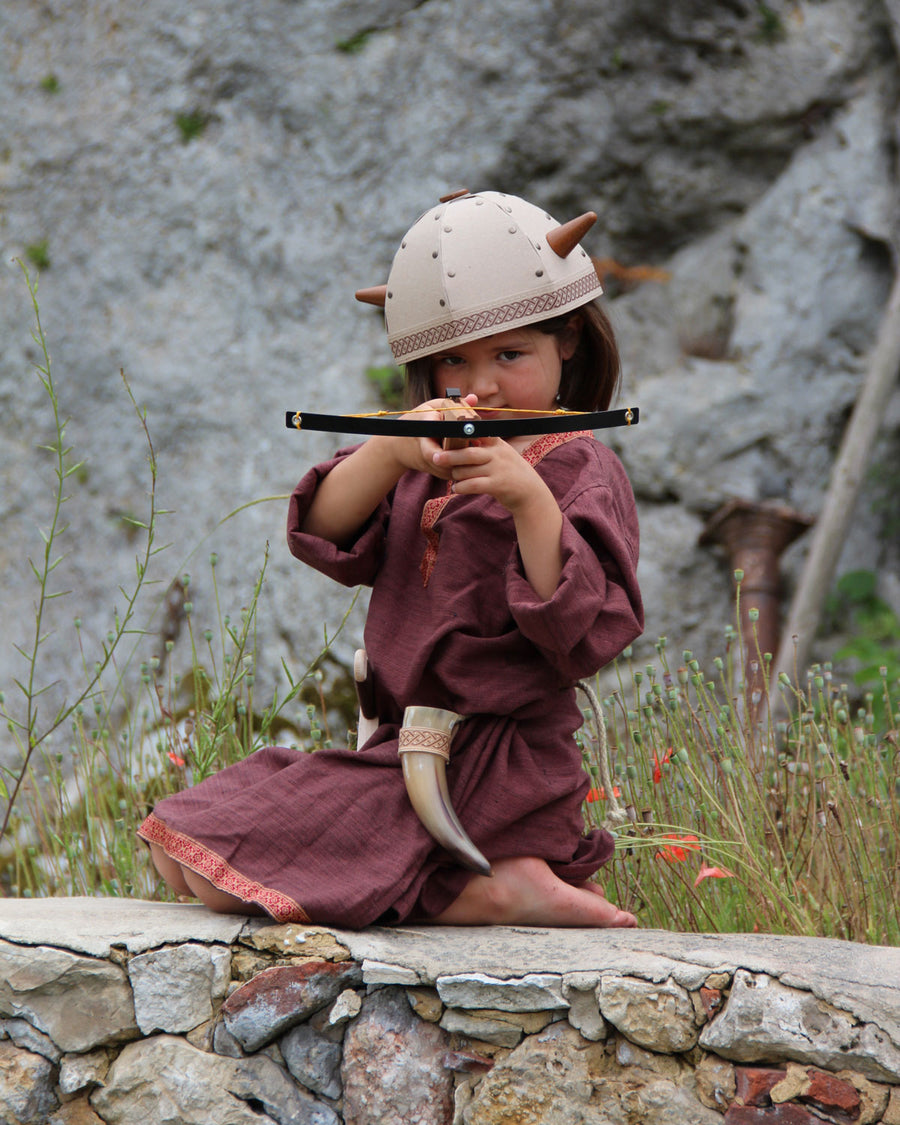 Child playing with the Vah Junior Wooden Bow toy