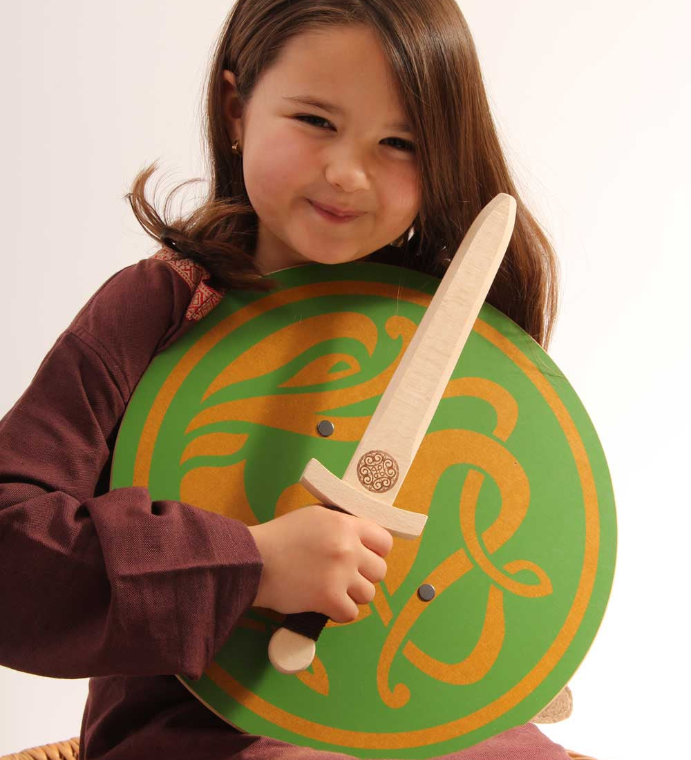 Child holding a Vah Wiki Wooden Dagger and a green celtic sigar round shield