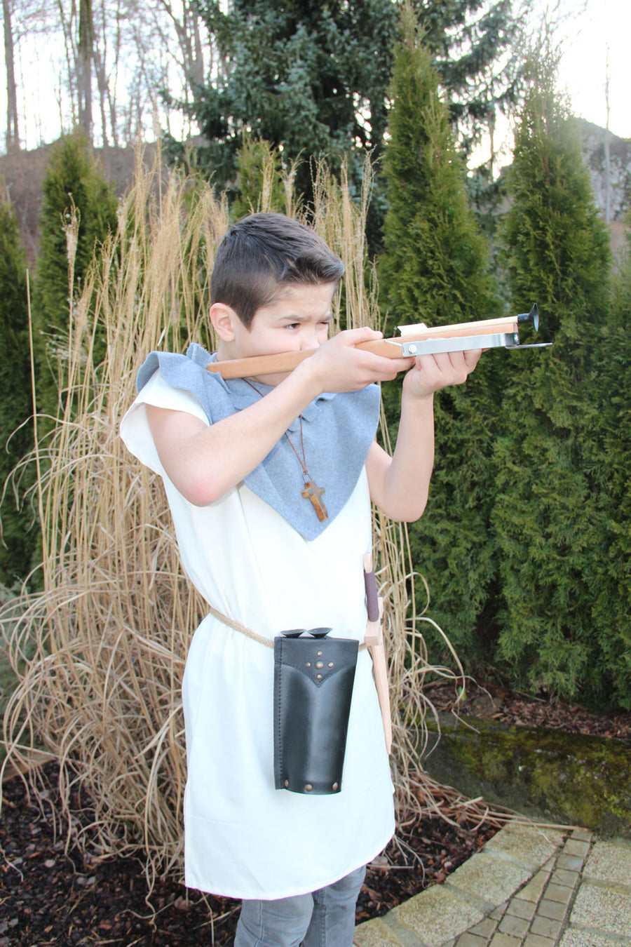 Child in fancy dress taking aim with the Vah Wooden Hunting Crossbow with Safety Arrows